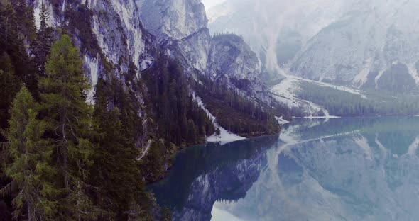 Aerial Drone Flight Establisher Over Lake with Clouds and Forest