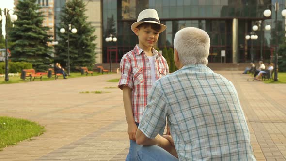 Senior Man Highfives with His Grandson