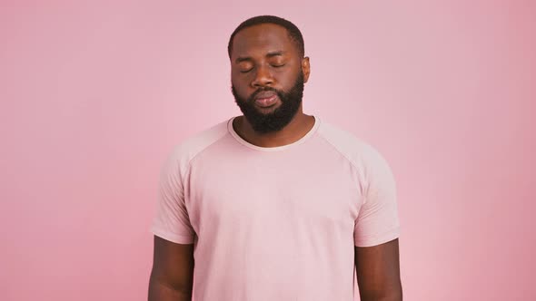 Serious Black Guy Gesturing Stop Looking at Camera and Shaking Head No Pink Studio Background