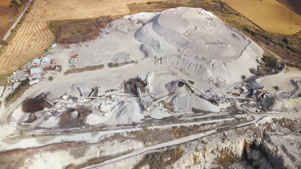 Aerial View of Slope Operating Granite Quarry with Mining Equipment on Ledges