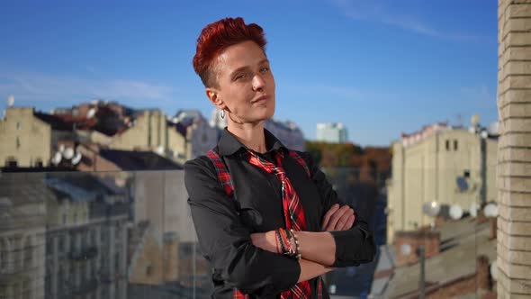 Medium Shot of Confident Caucasian Pierced Woman with Crossed Hands Posing in Slow Motion on Terrace