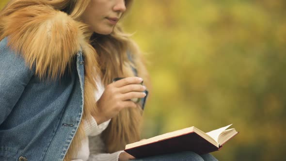 Woman Reading Book and Drinking Tea on Backyard, Enjoying Fall Weather, Pleasure