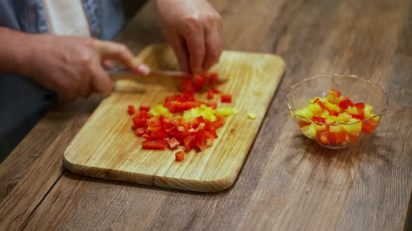 a man cuts a bell pepper. cooking process by the chef. salad ingredients. caring man preparing