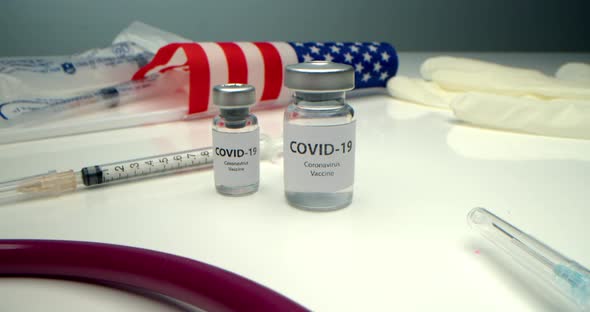 Vaccine Against COVID19 an Ampoule with a Vaccine Against Coronavirus and Various Syringes Nearby