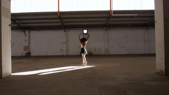 Female dancer in an empty warehouse