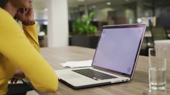 Video of biracial woman using laptop with copy space on screen