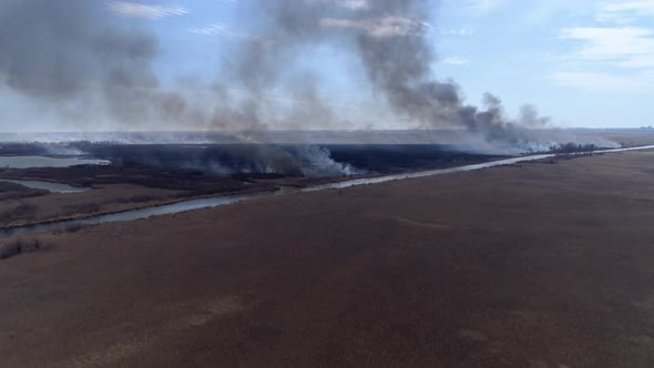 Nature Disaster, Large Flames Fast Moving By Dry Field with Black Smoke Going Up To Heaven Near