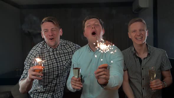 Happy Young Men Holding Sparkles