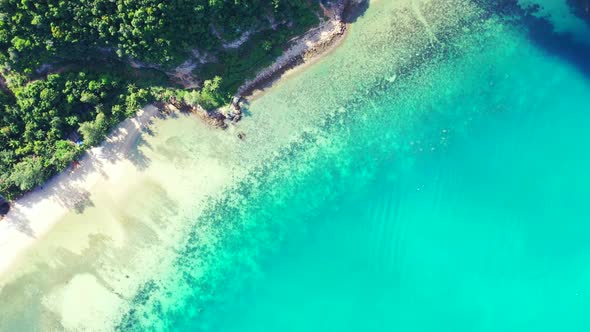 Aerial above panorama of beautiful tourist beach holiday by blue lagoon and white sand background of