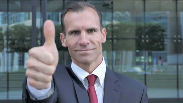 Thumbs Up By Middle Aged Businessman