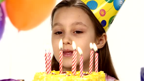 Birthday Girl Blows Out Candles on a Birthday Cake