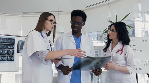 Multi National Doctors Discussing Lungs xray of the ill Patient