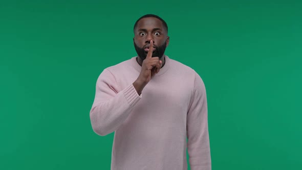 African American Man Showing Hush Gesture Isolated on Green Screen Chroma Key Background Keeping