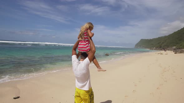 Father with Daughter with Child on the Beach