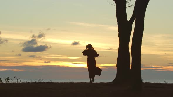 The Silhouette  Of A Lady With Her Mobile Phone.