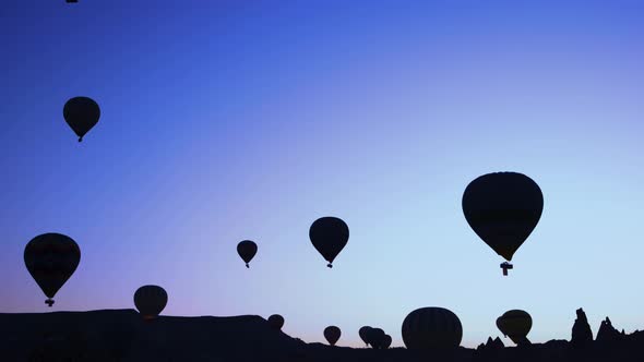 Silhouettes of Hot Air Balloons on Sunset Sky Background.