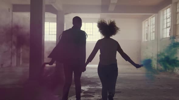 Fashionable young man and woman in an abandoned warehouse