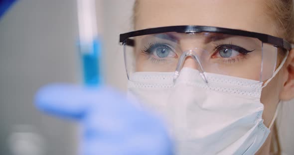 Doctor Carefully Drips Medicine From Pipette Into Sample Glass Tubes for DNA Analysis at Laboratory alt