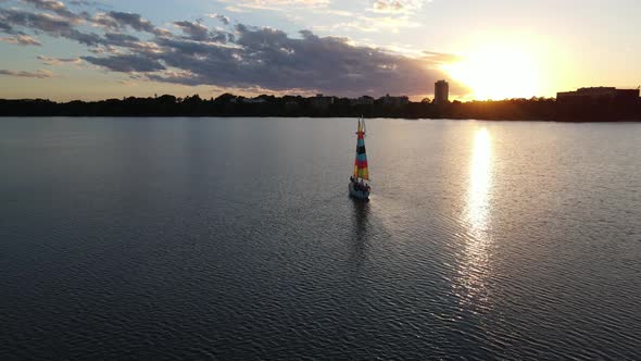 beautiful sunset at the lake with a boat sailing