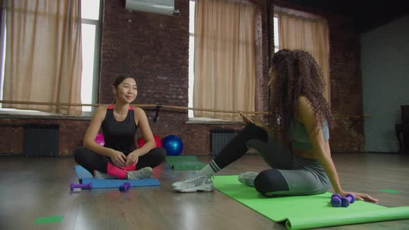 Multiracial Females Resting After Fitness Class