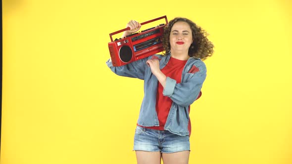 Girl Enjoying the Music and Dancing with the Red Boombox on Her Shoulder, Retro Style