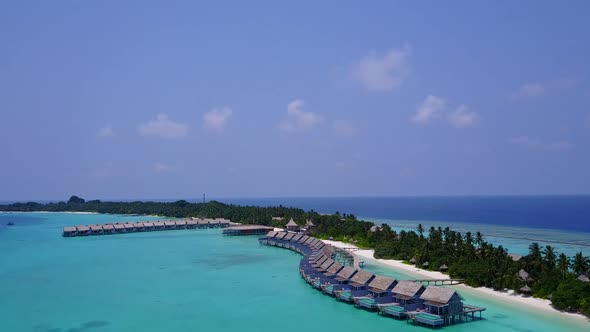 Aerial scenery of seashore beach by blue water with sand background