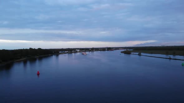 Cargo Ship Of Novalis Navigates The Calm River In Barendrecht Town In Netherlands. aerial