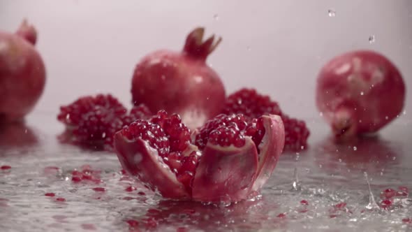 Falling Splitted Pomegranate Into the Water . Slow Motion