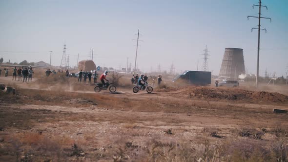 Skilled motocross rider on a sandy track, performing stunts on motorcycles, moto festival. Slow moti