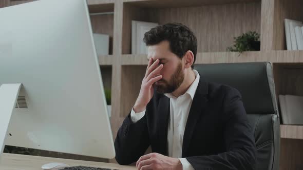 Serious Good Looking Office Working Professional Looks Frustrated and Disappointed at His Workplace