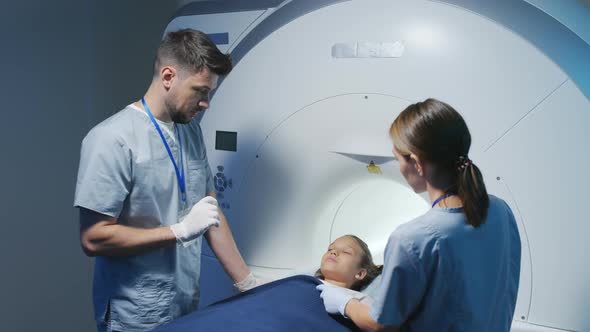 Doctors Explaining MRI Procedure Process to Little Girl