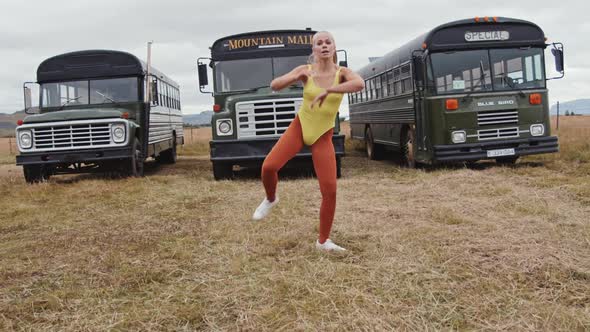 Girl In Yellow Performing Dance By Busses