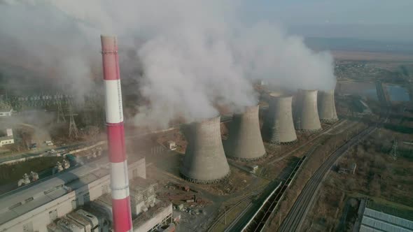 Aerial Drone View of Tall Chimney Pipes with Grey Smoke From Coal Power Plant