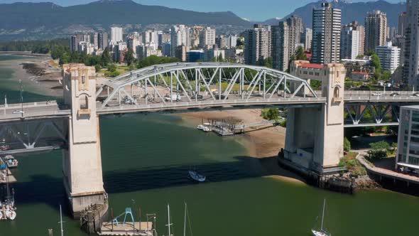 Aerial View Of Traffic Crossing Burrard Street Bridge With Waterfront Skyline In Background In BC, C