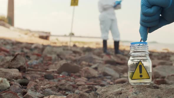 Scientist Taking Sample of Seaweed in Biohazard Zone