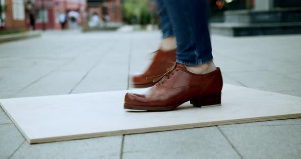 Closeup of the Legs of the Dancing Steppe in the Street in Front of Passersby