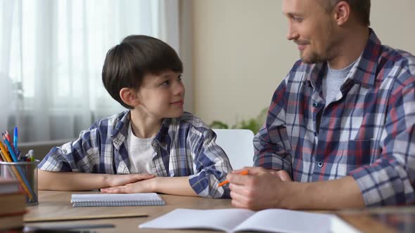 Son and Father Doing Homework Together, Giving High Five Each Other, Teamwork