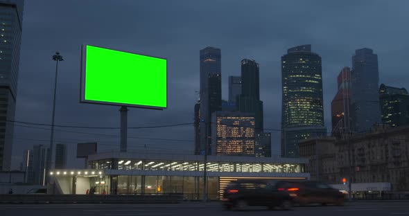 Green Screen Billboard on a Megapolis Highway with Neon Lights, Skyscrapers on Background