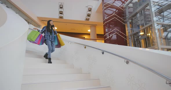 Young Asian Woman Talking on the Phone at the Mall