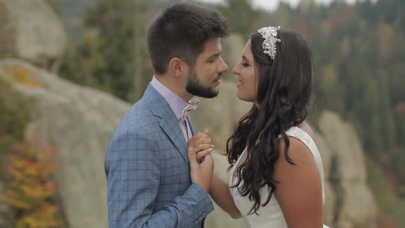 Groom with Bride on a Mountain Hills in the Forest. Wedding Couple