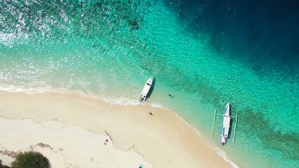 Daytime fly over clean view of a sandy white paradise beach and turquoise sea background in hi res 4