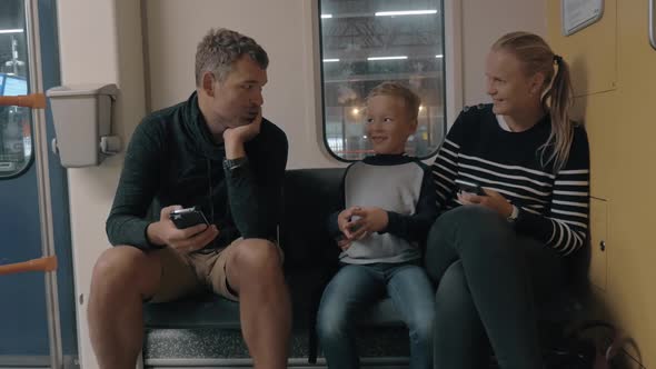 View of Happy Family in the Railway Trip Using Smartphone, Amsterdam, Netherlands