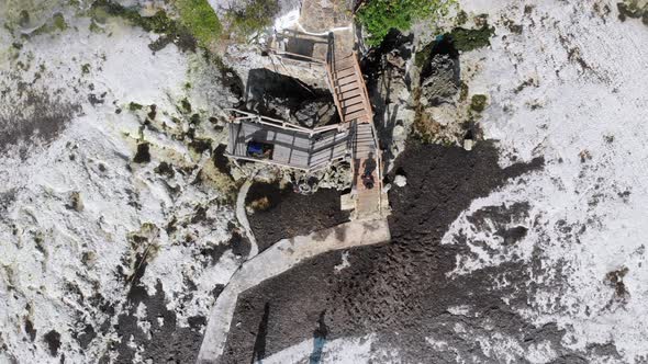 The Rock Restaurant in Ocean Built on Cliff at Low Tide on Zanzibar Aerial Top