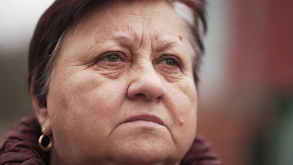 Portrait of Mature Woman Posing at Camera in Park