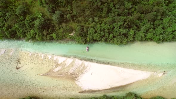 Aerial view of whitewater kayaker paddling on the Soca river, Slovenia.