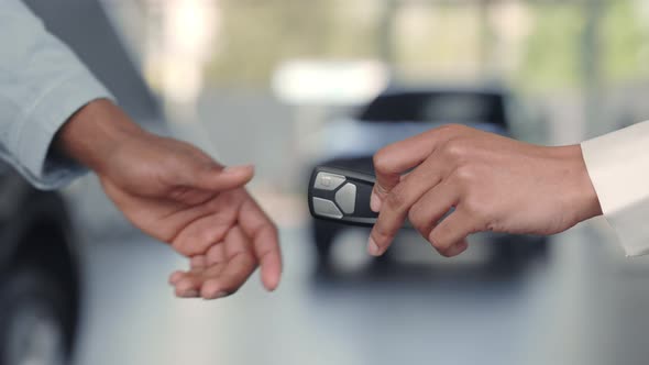 Car Manager Giving Keys to Customer and Shaking Hands