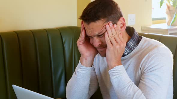 Depressed man using laptop 4k