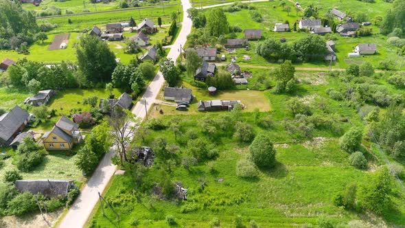 Aerial View of Countryside Homes in Suburbs of Small Lithuanian Town, Road, Houses and Green Land on