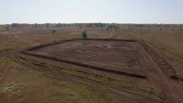 Oil Well in Field, Workers Are Going To It, Aerial View in Summer Day