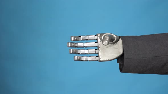 A Young Woman Shakes the Gray Mechanical Arm of a Cyborg. Handshake of Two Businessmen. Hands